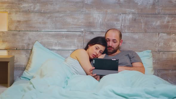 Caucasian Couple in Pajamas Lying in Bed