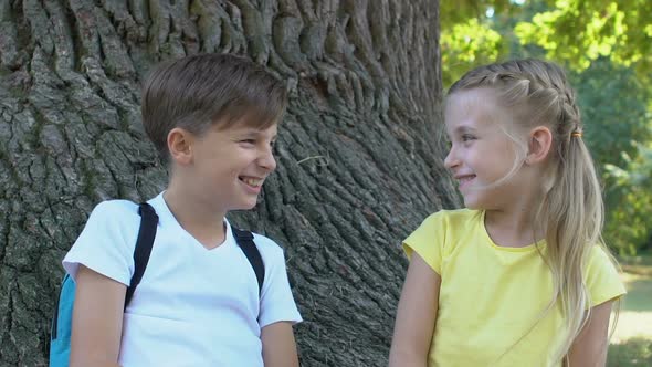 Cute Boy and Girl Smiling Each Other Sitting Park Tree Together, Friendship