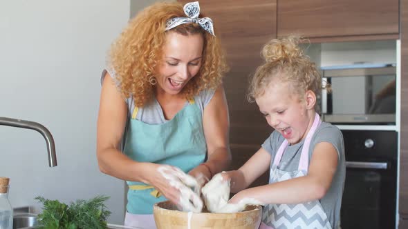 Mother and Child Daughter Girl Having Fun While Making Dinner at the Kitchen