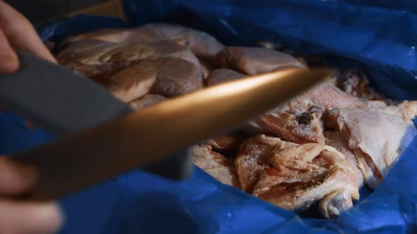 Closeup of Female Hands Sharpening Knife in the Kitchen Before Cutting the Meat