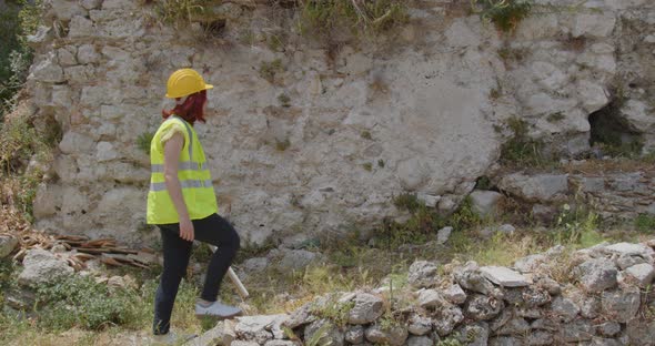 Female architect walks up a hill