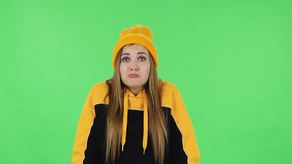 Portrait of Modern Girl in Yellow Hat Upset Is Shrugging and Sighing