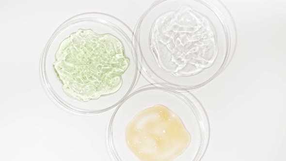 Rotation of Petri Dishes with Cosmetics Samples on a White Background