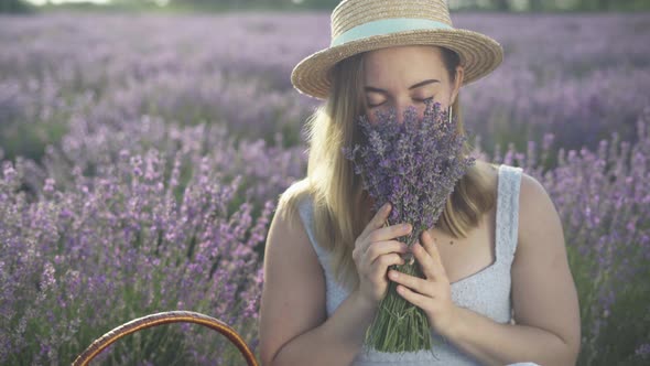 Closeup Portrait of Smiling Girl Sniffing Lavender Bouquet in Summer