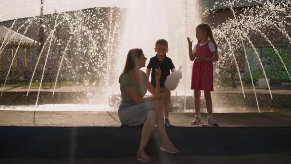 Woman Treats Children with Spun Sugar Against Waterworks