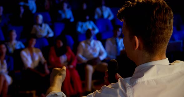 Young Caucasian businessman speaking in business seminar in auditorium 4k