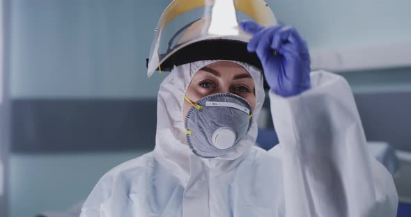 Female Doctor Taking Off Mask During Break