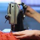 Woman sews on old sewing machine at home - VideoHive Item for Sale