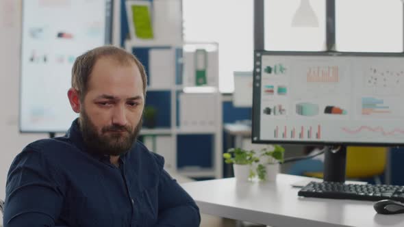 Close Up of Sad Disabled Entrepreneur Sitting in Wheelchair Looking at Camera