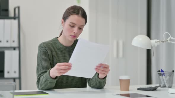 Young Woman Reading Documents