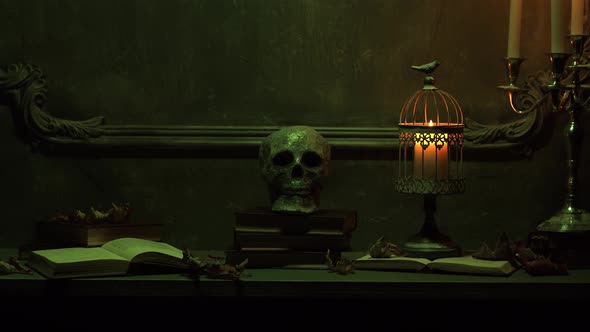 Mystical Halloween still-life background. Skull, candlestick with candles, old fireplace.