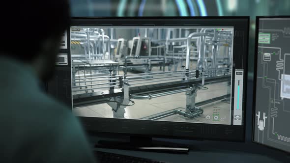 An Engineer supervises the conveyors using the program at the dairy facility