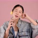 Happy pretty Asian teenager girl listening and sing a song by smartphone on pink background. - VideoHive Item for Sale