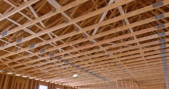 On the Construction of Wooden Building an Interior View of Wood Beams Framework Under Construction