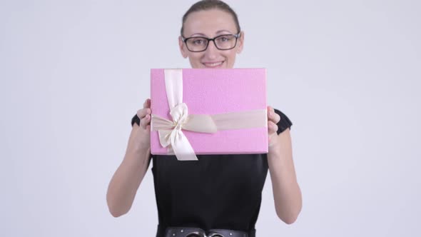 Happy Blonde Businesswoman Giving Gift Box