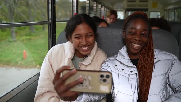 Pretty Schoolgirls Posing for Selfie on School Bus
