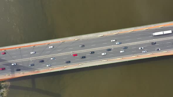 Car driving on highway bridge and road intersection in modern city aerial view