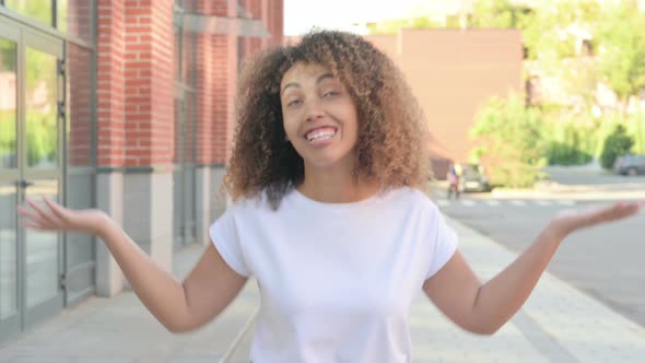 African Woman Talking on Video Call in Street