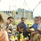 Beautiful girl taking photos of friends at party on a rooftop terrace - VideoHive Item for Sale