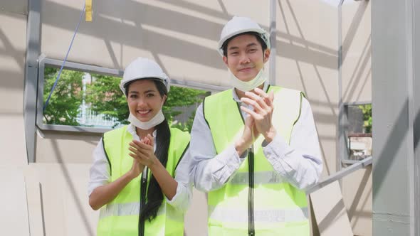 Asian workers people removes protective face mask onsite of architecture due to COVID19