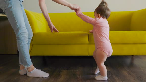 Slow Motion of Lovely Caucasian Baby Girl Learning to Walk Taking First Step Walk