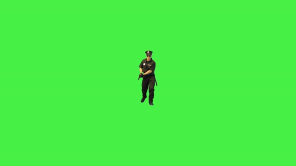 Young Caucasian Policeman Walks with Gun in Hands on the Alert on a Green Screen Chroma Key