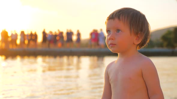 Toddler Standing on the Seashore During Sunset. Mental Health. Children Psychology. Facial