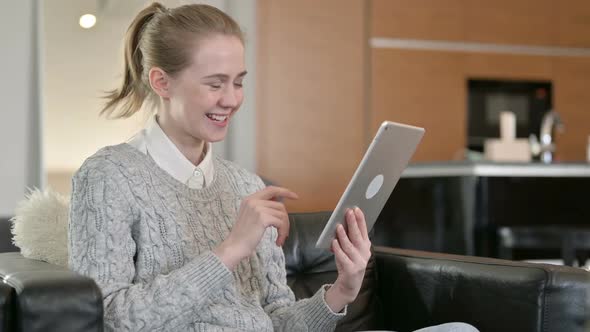 Cheerful Young Woman Doing Video Call on Tablet at Home