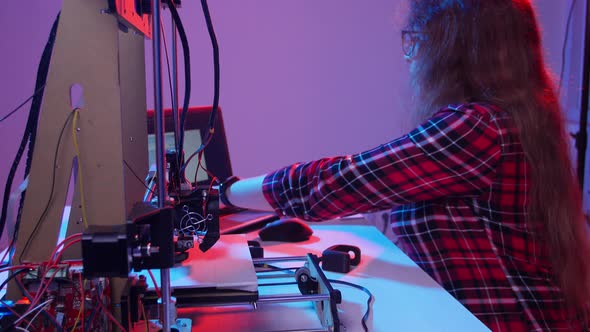 Concept of Modern Production Technologies. Young Woman Student Makes the Item on the 3D Printer