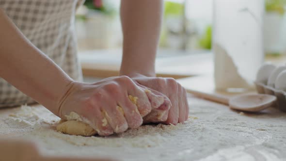 Closeup Female Hands Knead Dough on Table Using Wheat Flour Prepares Bread Baking at Home in Modern