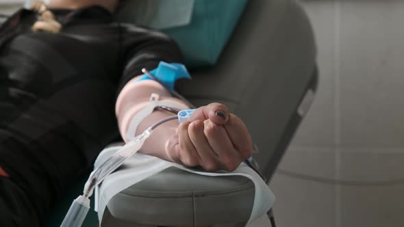 Blood Donor at Donation at Medical Centre. Close Up Footage Arm of Woman Receiving Blood in Hospital