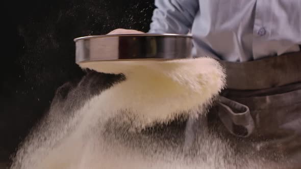 Woman is Sifting Flour Through Sieve for Baking