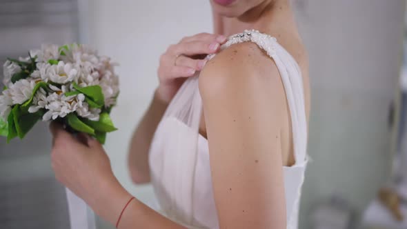 Side View Unrecognizable Slim Young Woman Touching Wedding Dress Strap Smiling