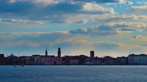 Vessels Sail on Blue Sea Against Historic City at Dawn