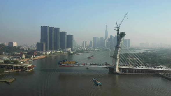 Drone view of Saigon River, Ho Chi Minh City and new Thu Thiem Bridge under construction on a sunny