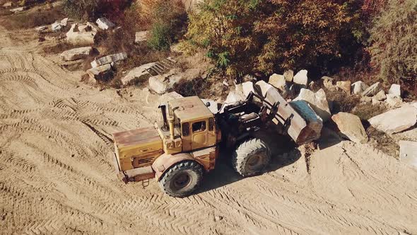 Specially Equipped Machine With a Bucket id Working Near a Quarry With Stones