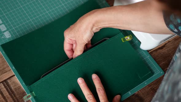 Craftsman is creating a felt case for tablet. Process of the cover testing and fitting