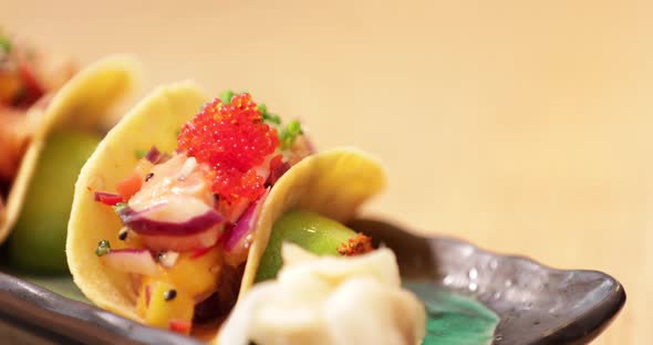 Chef Putting Wasabi On The Side Of Sushi Tacos Before Serving.  - close up shot