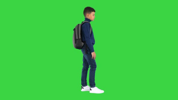 Boy in Polo Neck Standing with a Backpack on a Green Screen Chroma Key