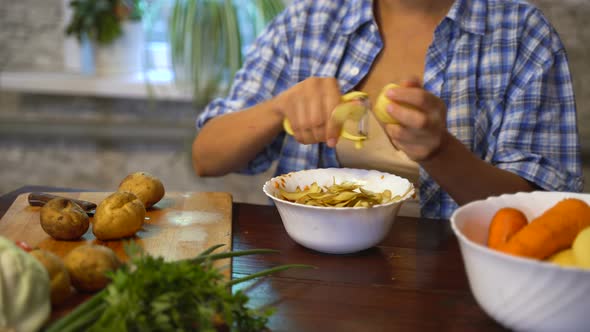 Pregnant woman at home in the kitchen cooks food