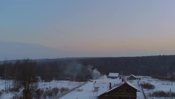 Sunset on Winter Landscape Beautiful Home in the Village the Smoke Comes From the Chimney