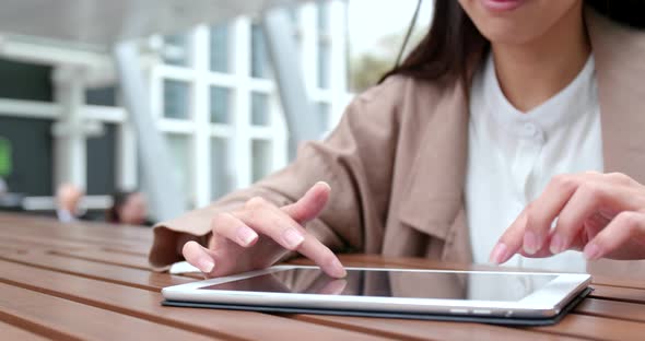 Woman use of tablet computer at outdoor cafe