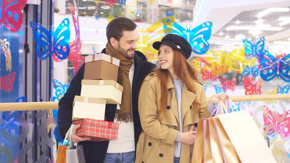 Young Caucasian Couple Having Fun in Shopping Centre or Mall