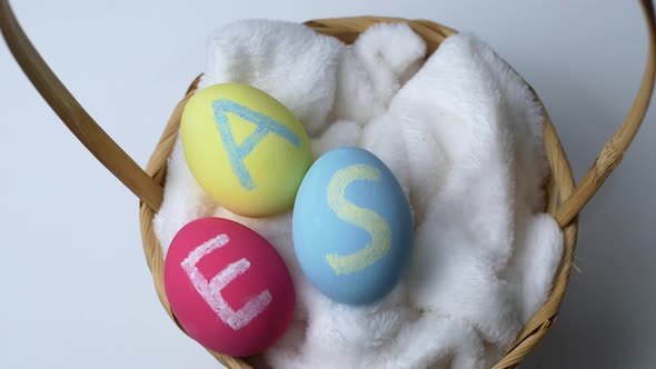 Easter animation colorful egg in a basket isolated on white background. Easter concept.