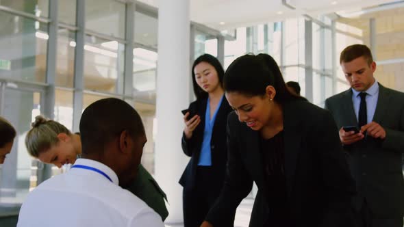 Business people checking in at conference registration table 4k