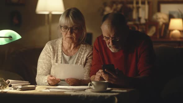 Senior Couple Calculating Utility Payments Together