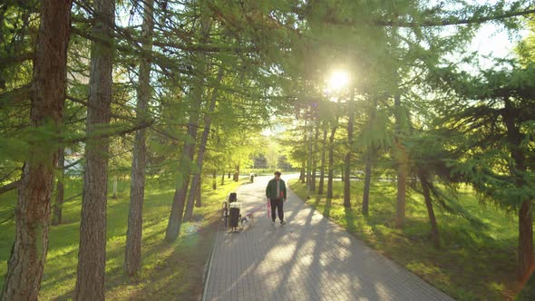 Man Going with Dog through Park