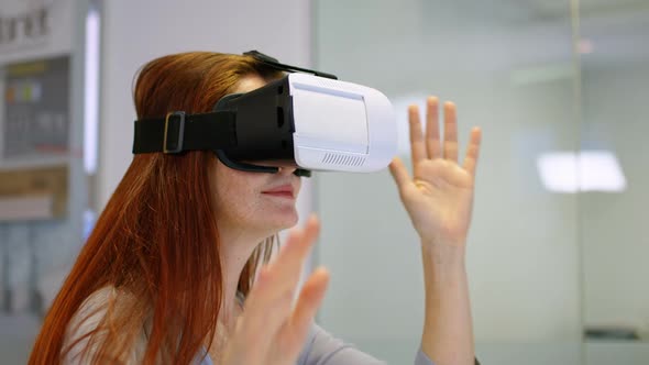 Businesswoman using virtual reality headset in a modern office 4k