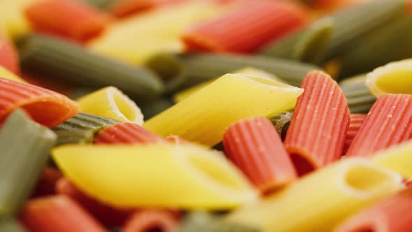 Closeup of Rotating Colourful Macaroni on Table