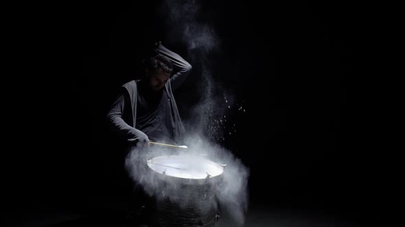 Portrait of a Drummer in Profile on a Black Background